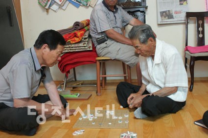 경로당 한켠에서 노인회원들이 장기를 두고 있다.
