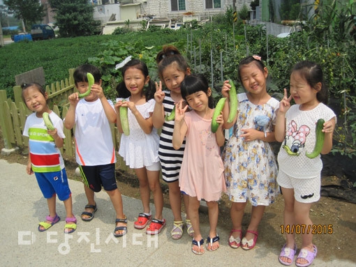 ▲ 텃밭에서 수확한 채소를 들고 있는 송악어린이집 원아들